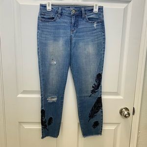 Mid rise dark wash cropped jeans with feather detail distressed skinny